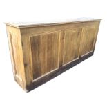 A rectangular oak bar unit with mouldings framing top, having panels to front and sides, with open