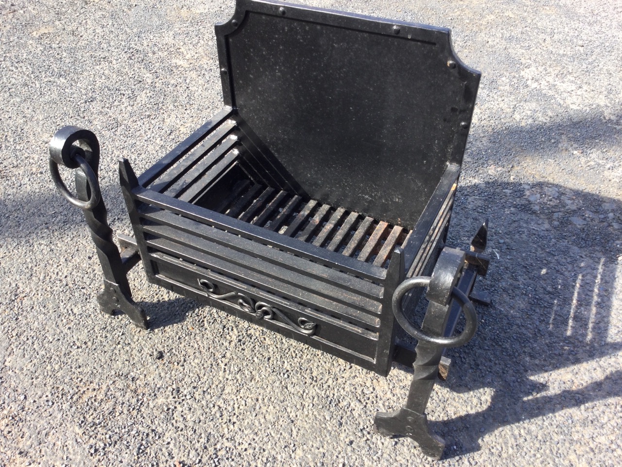 An C18th style cast iron firegrate, with panelled fireback and basket grate supported on fire dogs - Image 2 of 3