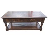 A rectangular oak coffee table, the moulded dowelled plank top above a frieze with two drawers,