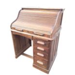 An Edwardian oak roll-top desk, the tambour with label Entirely English Make HLL, enclosing an