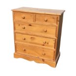 A Victorian style pine chest of drawers, having rectangular moulded top above two short and three