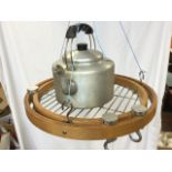A contemporary kitchen utensil hanger with circular grill tray with revolving hooks; and an