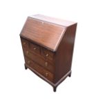 A Stag mahogany bureau with moulded fallfront enclosing an interior with writing surface and