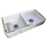 An Adelphi double Belfast sink, each rounded basin with integral overflow, having chrome waste