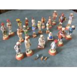 A collection of handpainted Indian model clay figures depicting various servants and trades -