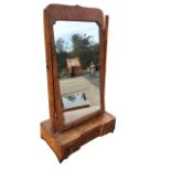 An eighteenth century Queen Anne walnut dressing table mirror, with moulded frame on tapering