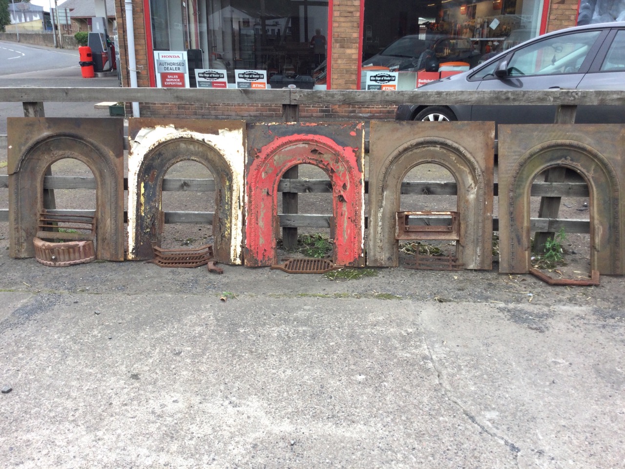 A set of three nineteenth century arched cast iron fire inserts with flowerhead embossed castings; a - Image 2 of 3