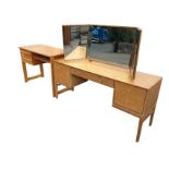 A Stag oak dressing table with three mirrors on rectangular top above an arched frieze drawer