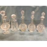 A set of three nineteenth century cut glass decanters & stoppers of ball shape with faceted necks