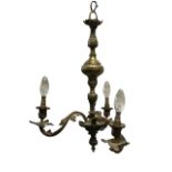 An Edwardian hanging brass light fitting with three rococo leaf branches supporting candlelights