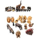 A collection of carved and moulded animals including a set of graduated elephants, horses, dolphins,