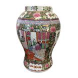 A Chinese famile rose style baluster shaped vase decorated in the Canton style with alternating