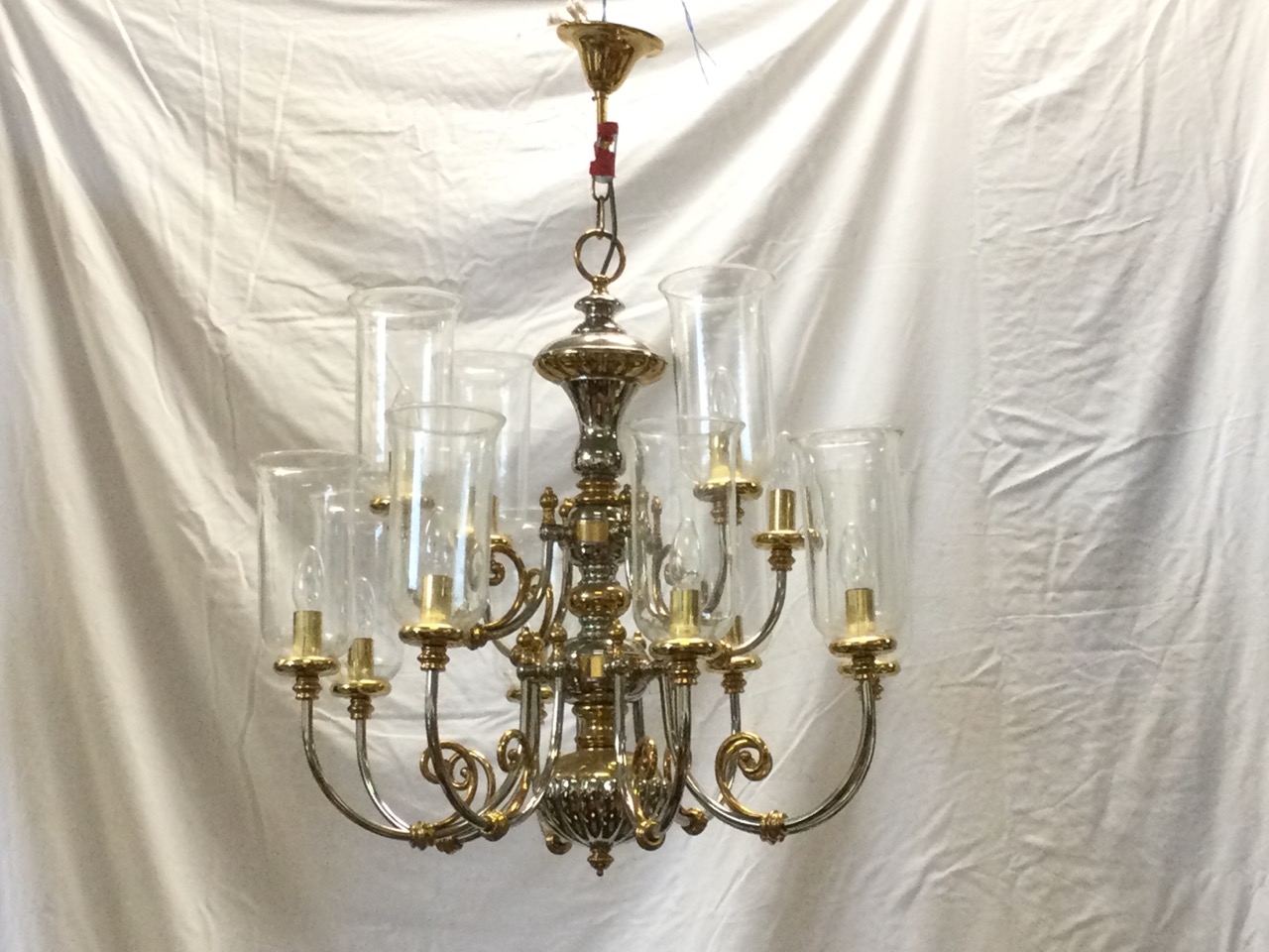 A large Dutch style silvered & gilt brass chandelier, with two tiers of scrolled branches supporting