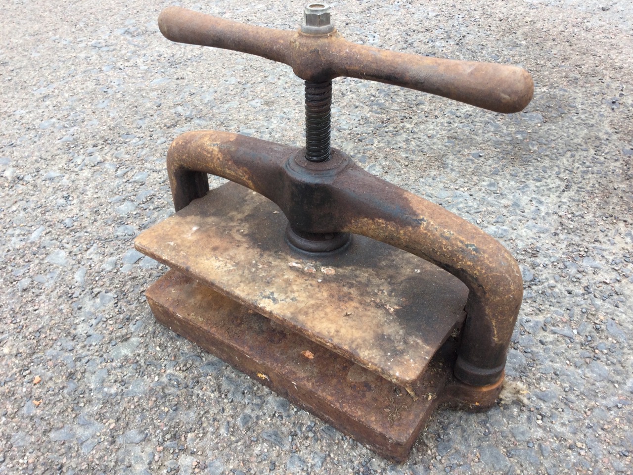 A Victorian rectangular cast iron press with screw mechanism and shaped swinging handle. (19in)