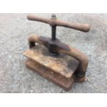 A Victorian rectangular cast iron press with screw mechanism and shaped swinging handle. (19in)