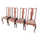 A set of four mahogany Queen Anne style dining chairs with vase shaped splats above leather drop-