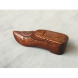A nineteenth century carved mahogany snuff box in the form of a shoe, the sliding lid with chisel