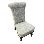 A Victorian mahogany chair with upholstered high back above spade shaped sprung seat, raised on