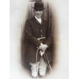 A Victorian oak framed three-quarter length sepia photograph of a young huntsman, signed in pencil