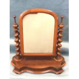 A Victorian mahogany dressing table mirror with arched cushion moulded frame supported on twisted