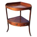 A Georgian mahogany corner stand, the top with gallery above a shaped apron, raised on square