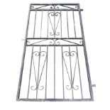 A wrought iron garden door with vertical bars and scrolled decoration. (58in x 32.25in)