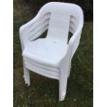 A set of four stacking plastic moulded garden chairs with panelled seats. (4)
