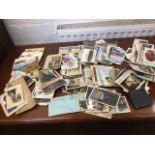 A box of miscellaneous loose postcards - sentimental, seaside cartoons, topographical, some silks,
