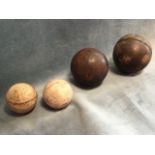 A pair of leather mounted fives balls, hand-sewn with quartered skin; and two old cricket balls. (