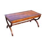 A rectangular mahogany coffee table, the crossbanded moulded top with plain apron raised on cradle