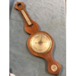 A rosewood nineteenth century barometer with missing dry/damp dial, above an arched rectangular