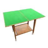 An oak trolley card table, the baize lined twin turn-over-top on square tapering column legs with