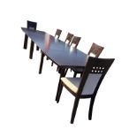 A contemporary extending dining table, the shaped rectangular top with four leaves, supported on