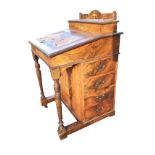 A nineteenth century rosewood boxwood strung and scrolled marquetry inlaid davenport, the top with