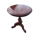 A circular mahogany coffee table, the moulded top raised on a fluted turned column, with scroll