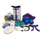A box of miscellaneous fitness/exercise stuff including a pilates ball, a boxed shaper, weights, a