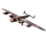 A large wood model of a Lancaster bomber with metal propellers, perspex cockpit, rubber wheels, etc.