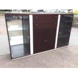 A contemporary faux walnut illuminated cabinet with glass doored mirrored shelves framing central