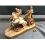 A Royal Dux porcelain model of a roman chariot lead by a pair of rearing horses and driven by a