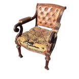 A George IV mahogany armchair with button upholstered back in moulded frame with scrolled arms