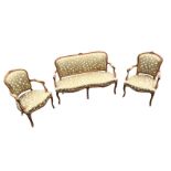 An elegant Louis VI style carved suite with sofa and pair of fauteuils, the rounded backs in moulded