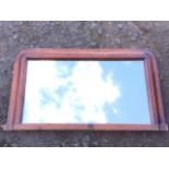 A Victorian walnut overmantle mirror with rectangular plate in crossbanded cushion moulded frame