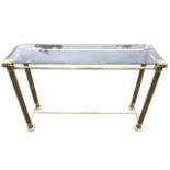 A contemporary rectangular glass hall table, the bevelled plate supported on octagonal brass columns