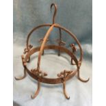 A wrought iron kitchen hanger in the form of crown with twisted supports, having eight hooks with