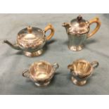 A hallmarked silver four-piece teaset decorated with embossed celtic bands to rims, the teapot & jug