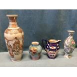 A tall Japanese stoneware satsuma vase decorated with figural panels on honeycombed ground -