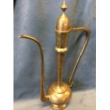 A large Persian brass coffee pot with domed hinged lid above a tapering neck and bulbous body, all