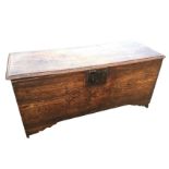 An eighteenth century six-plank elm coffer with rectangular moulded top mounted with iron hinges,