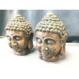 A pair of gilded Buddha heads with verdigris decoration to scrolled hair nodules. (10in) (2)
