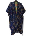 An embroidered Japanese silk kimono with gilt dragons, clouds and exotic birds on blue ground.